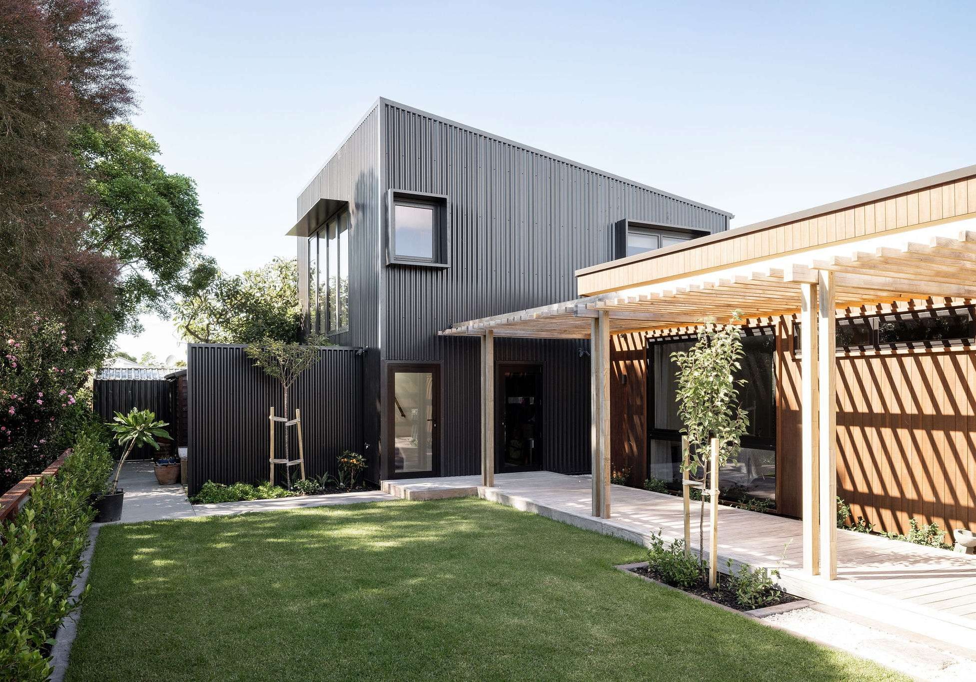 new black architectural home in Tauranga with gazebo and nicely manicured garden